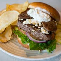 Tower Inn Cafe's "The Gyro Burger"  a beef patty topped with thick gyro meat, feta cheese, cool Tzatziki sauce, lettuce and tomato, served with a side of and cut chips. Tower Inn Cafe is located at 701 West Cross Street in  Ypsilanti.Courtney Sacco I AnnArbor.com 